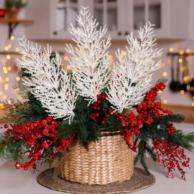 White artificial pine sprays styled in a basket for holiday table décor