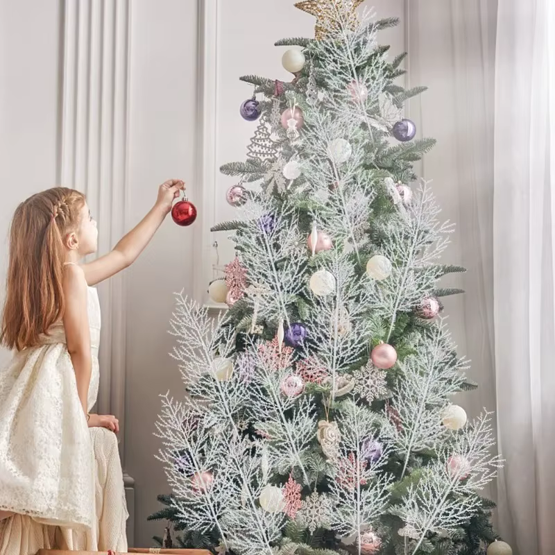 Adding white pine picks to a flocked Christmas tree for layered snowy texture
