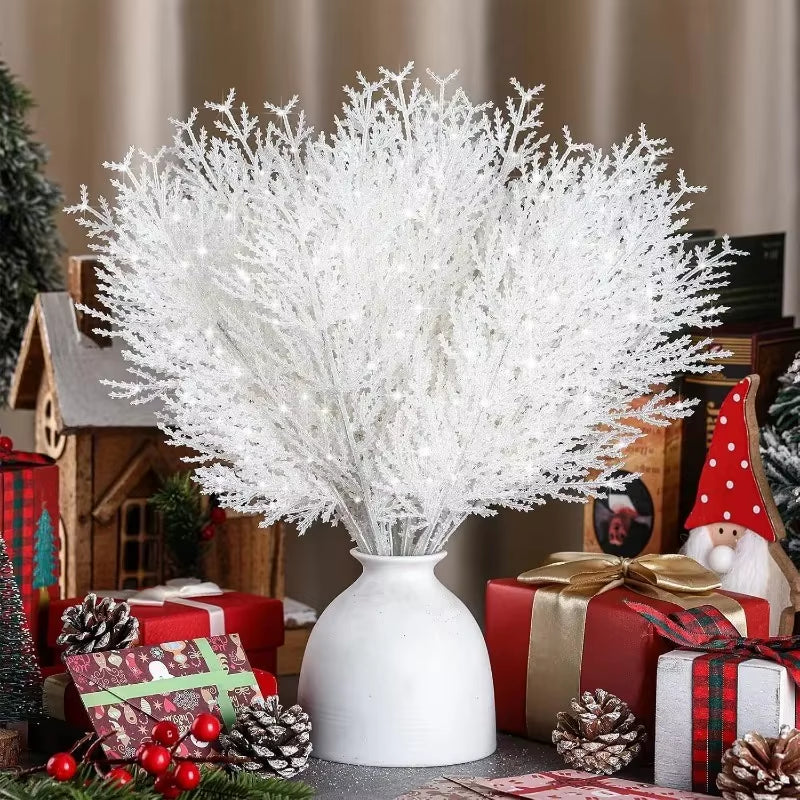 Large bouquet of white artificial pine branches arranged as a winter table centerpiece