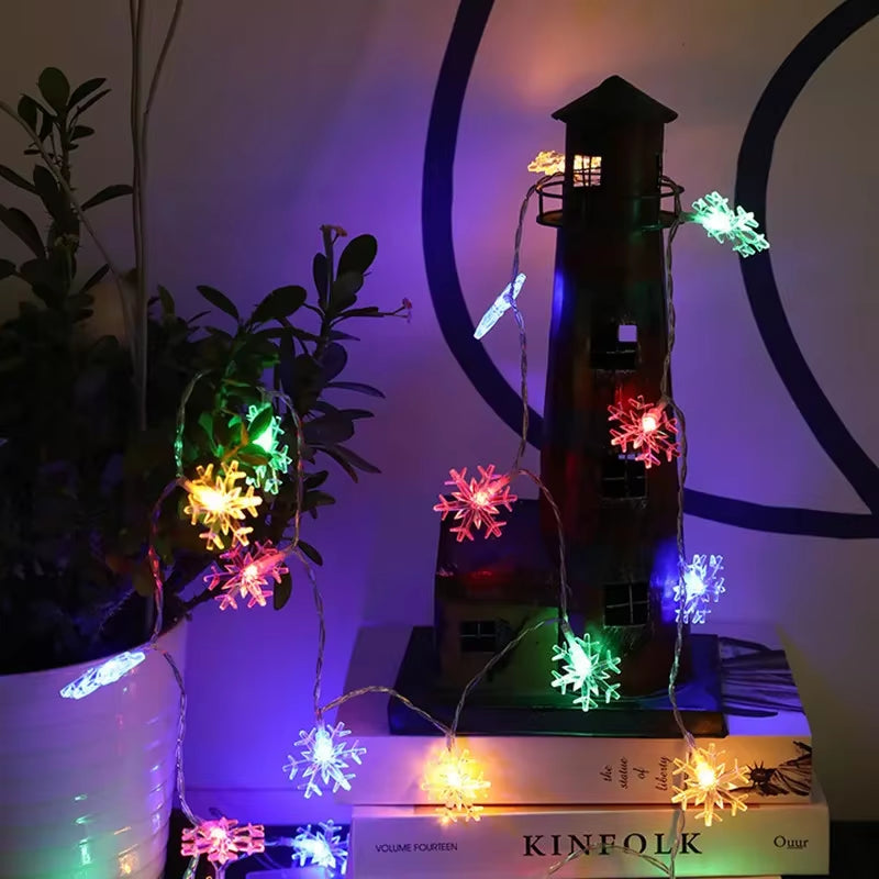 Multicolor snowflake string lights wrapped around a plant stand creating party vibes